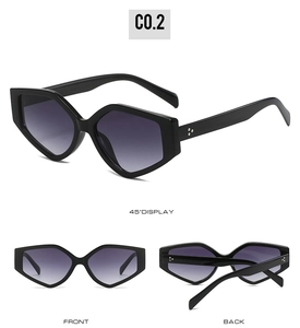 Detail view showing black geometric triangle sunglasses with gradient purple lenses and rivets