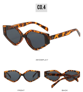 Detail view of triangular tortoise sunglasses with dark lenses and metal rivets at hinges