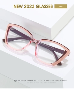 Detail view of pink purple gradient cat-eye blue light blocking glasses on white stand