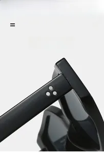 Close-up of black glossy sunglasses hinge with three silver rivets and sleek modern design