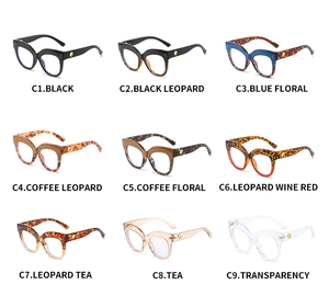 Collection of nine colorful cat eye eyeglass frames with vintage rivets and gold accents