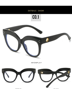 Detail view of oval cat eye glasses frame with silver rivets and metal ring temples