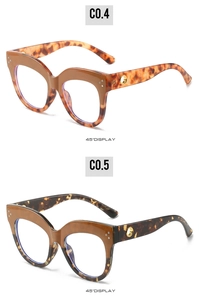 Detail view of oval cat-eye frames featuring retro rivets and hollow metal temple rings