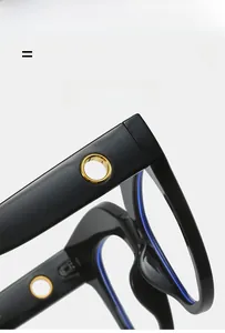Detail of black oval glasses frame showing a golden metal hinge and flexible temple