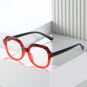 Red and black tortoiseshell TR square anti-blue light glasses on white geometric stand
