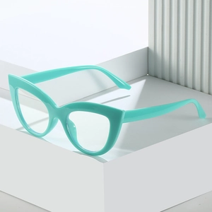 Fashionable mint green cat eye glasses frame on a minimalist geometric white stand