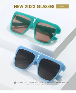 Detail of square flat-top sunglasses with a white V-shaped accent on the bridge
