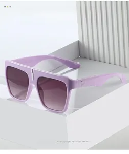 Detail of lavender oversized sunglasses with rhinestone accents and gradient lenses