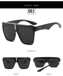Detail of square oversized black sunglasses with silver star rivets on the temples