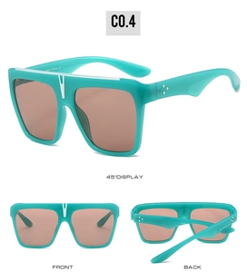 Detail view of teal square sunglasses with a V-shaped nose bridge and silver temple dots