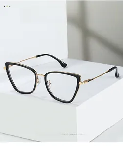Modern cat-eye TR90 eyewear frame in black and gold finish on minimalist display