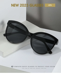 Detailed macro view of black cat-eye sunglasses legs showing model M373 specifications