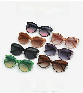 Collection of oversized sunglasses in black, tortoiseshell, and green with gradient lenses