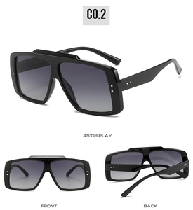 Multi-angle views of large frame sunglasses with rivets and grey gradient lenses