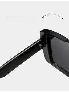 Close-up of durable textured metal hinge on black rectangular fashion sunglasses