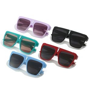 Flat lay of retro square oversized sunglasses in five vibrant colors with V-shape detail