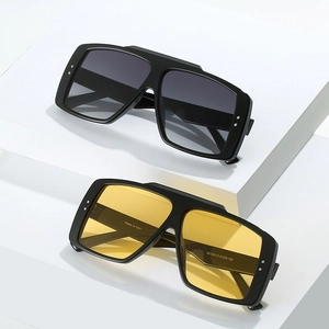 Oversized rectangular sunglasses with rivet decor on stylish white geometric stairs