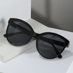 Fashionable black oversized sunglasses with UV protection for street style and beach travel
