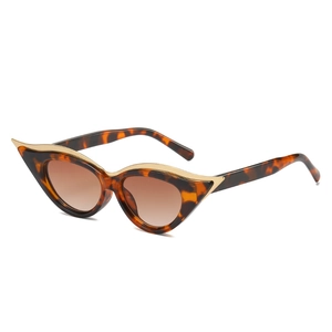Cat eye sunglasses with tortoise frame and gold metal trim in a 45-degree side view