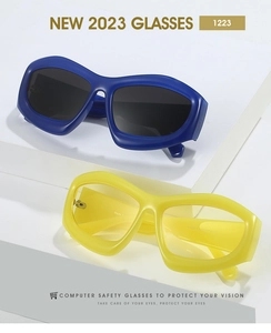 Close-up of matte blue and clear yellow cat-eye frames on a white geometric stand