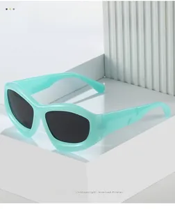 Detailed view of mint green thick-frame sunglasses with black lenses on white pedestal