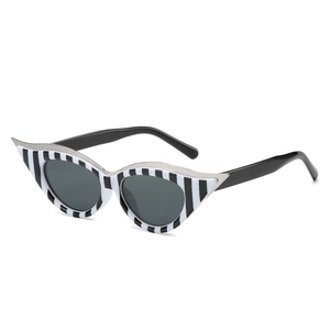 Retro cat-eye sunglasses with black and white vertical stripes and silver metal trim