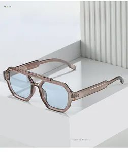 Detailed close-up of geometric tea-colored sunglasses with blue lenses on white steps