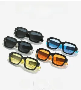 Flat lay of multiple trendy square sunglasses with colorful lenses and thick black frames