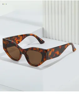Detailed close-up of retro cat-eye sunglasses with tortoise shell texture and brown lenses