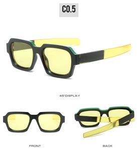 Detail view of square fashion sunglasses with thick black frames and yellow tinted lenses