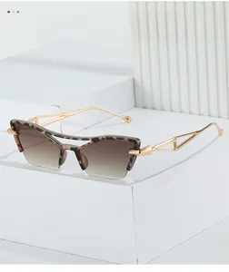 Detail of cat-eye leopard sunglasses with gold hollow metal temples on display