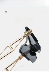 Detail of cat eye sunglasses showing golden metal hollow temples and elastic hinges