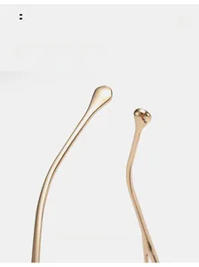 Detail of curved golden metal temples with smooth drop-shaped ends for cat eye sunglasses