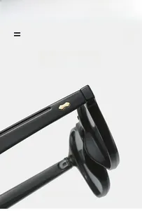 Detailed close-up of glossy black temples with golden metal rivets on punk sunglasses