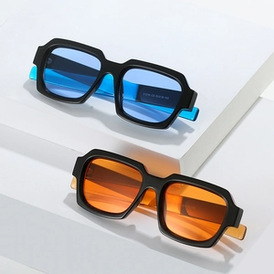 Modern square frame sunglasses with colorful translucent blue and orange temples on stone