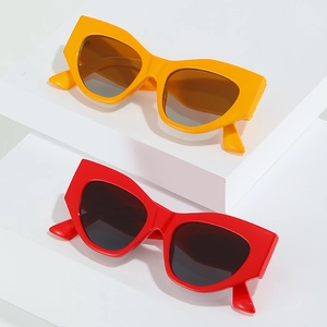 Modern wide-frame cat-eye sunglasses in bright yellow and bold red with geometric thick frames