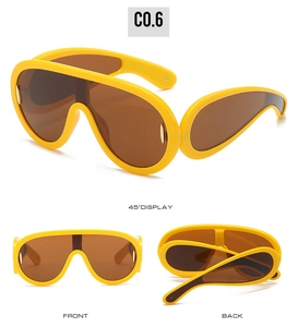 Three-angle view of futuristic yellow oversized shield sunglasses with brown lenses