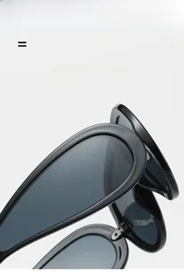 Detail of high-gloss black futuristic sunglasses showing the durable frame and smooth edges