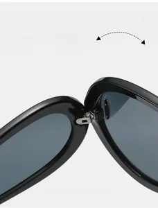 Detail of durable silver metal hinges on black futuristic wrap-around sunglasses