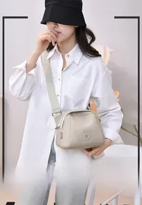 Beige lightweight oxford nylon crossbody bag with multi-layer zippers and adjustable strap