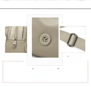 Close-up of smooth metal zippers and embossed logo on beige oxford shell bag