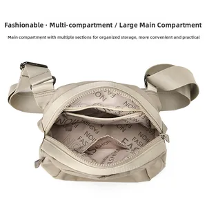 Macro view of beige nylon crossbody bag showing multiple inner compartments and lining