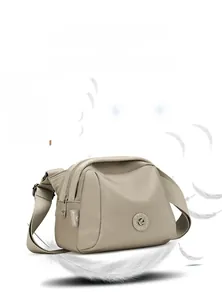 Detailed close-up of lightweight beige nylon shell bag weighing only 280g with logo
