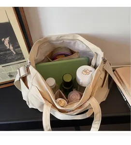 Interior view of spacious beige oxford tote bag with zipper pocket and everyday essentials
