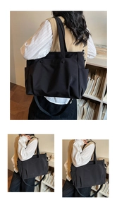 Detail of black oxford tote bag showing durable fabric handles and adjustable strap