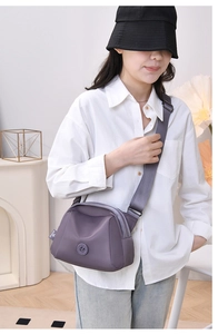 Model wearing purple oxford shell bag with wide strap and minimalist design
