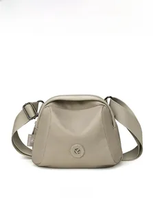 Detailed front view of light brown nylon shell crossbody bag with multi-layer zippers