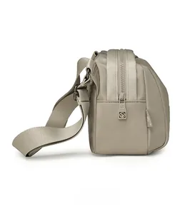 Side view of beige nylon shell bag showing thickness, fabric strap and KASO brand zipper