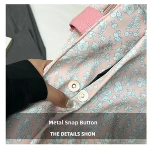 Detail of the high-quality silver magnetic snap closure on the floral canvas tote bag