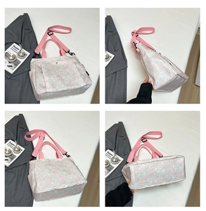 Detail view showing pink floral tote bag with adjustable strap and durable canvas texture